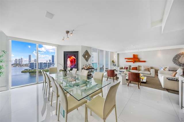 dining area featuring light tile floors and floor to ceiling windows