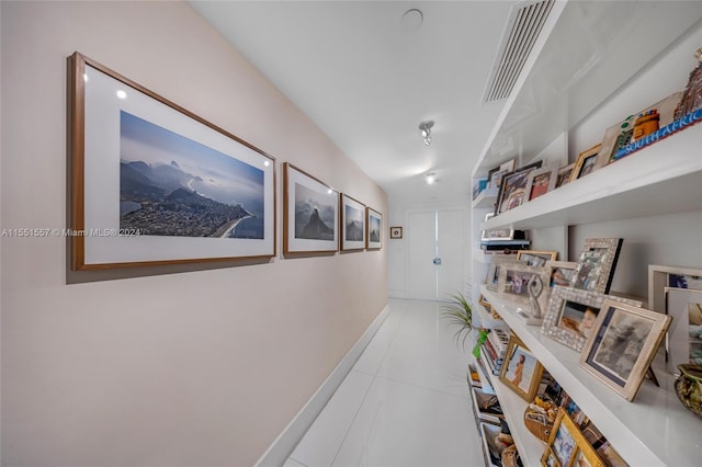 hall featuring light tile flooring