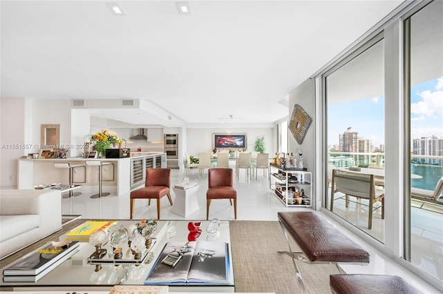 tiled living room featuring a wall of windows