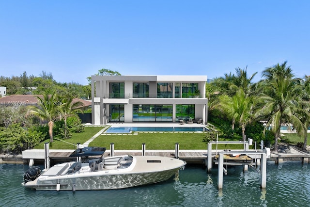 rear view of house featuring a patio, a water view, a balcony, and a lawn