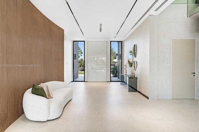 living area with wood walls and floor to ceiling windows