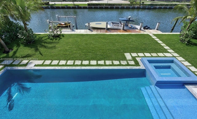 view of swimming pool featuring a boat dock, a water view, and a lawn