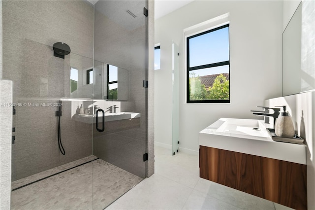 bathroom with tile patterned flooring, vanity, and an enclosed shower