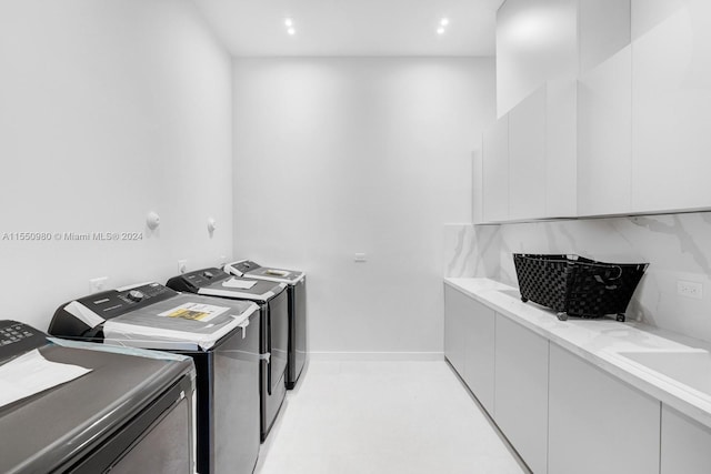 laundry area with independent washer and dryer