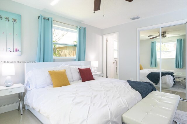 bedroom with light tile floors, a closet, and ceiling fan