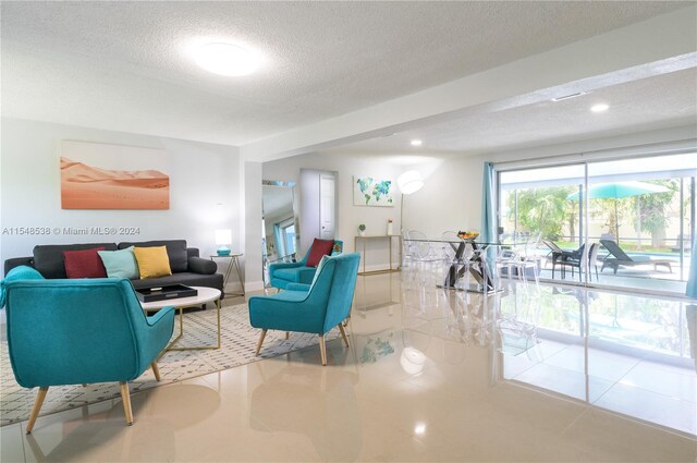 tiled living room with a textured ceiling