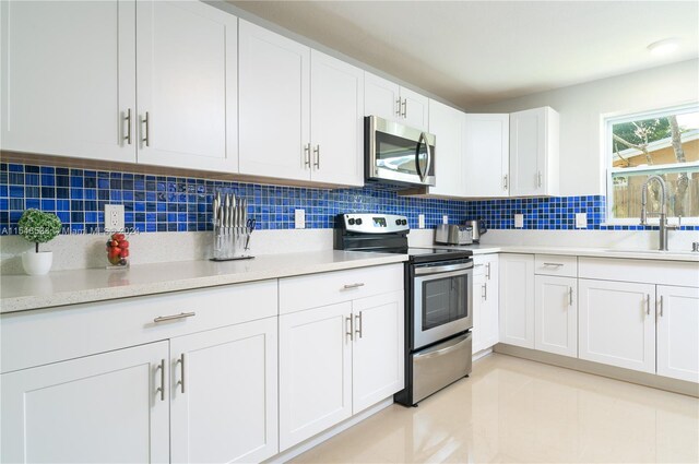 kitchen with white cabinetry, appliances with stainless steel finishes, and sink