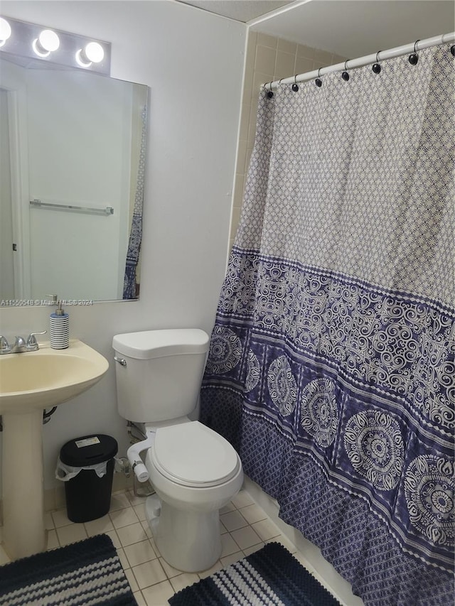 bathroom with tile flooring and toilet