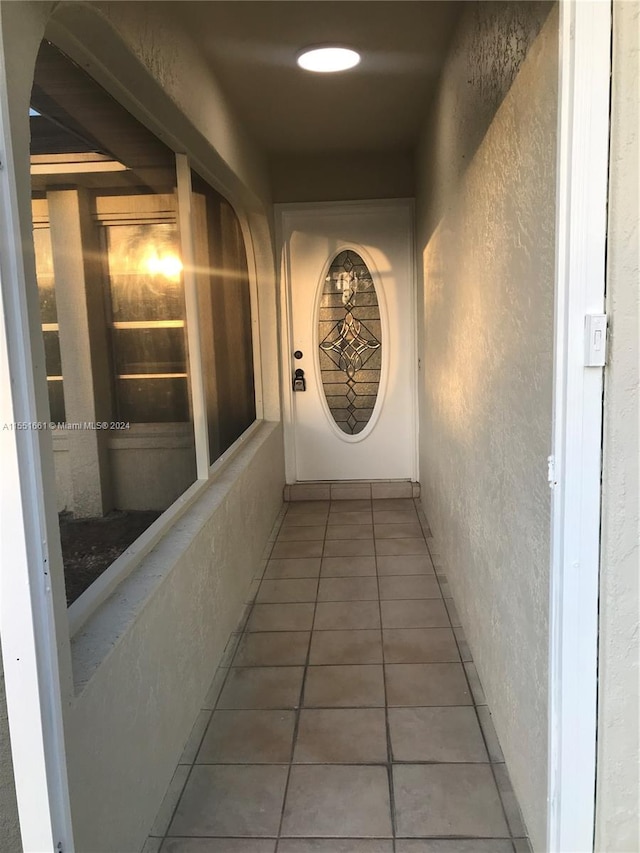 hallway with tile flooring