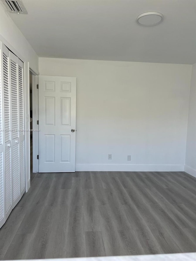 empty room with dark hardwood / wood-style flooring