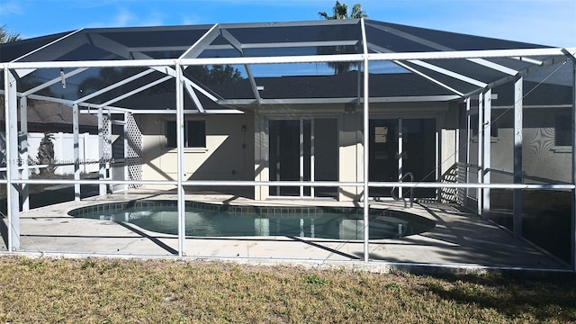 rear view of house featuring a lanai and a patio area