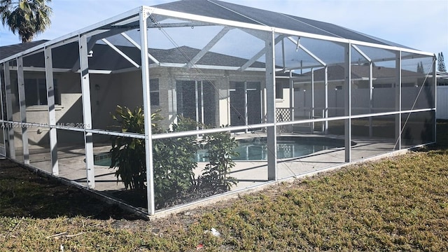 view of swimming pool with glass enclosure