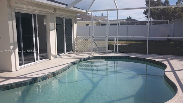 view of swimming pool with a lanai and a patio area