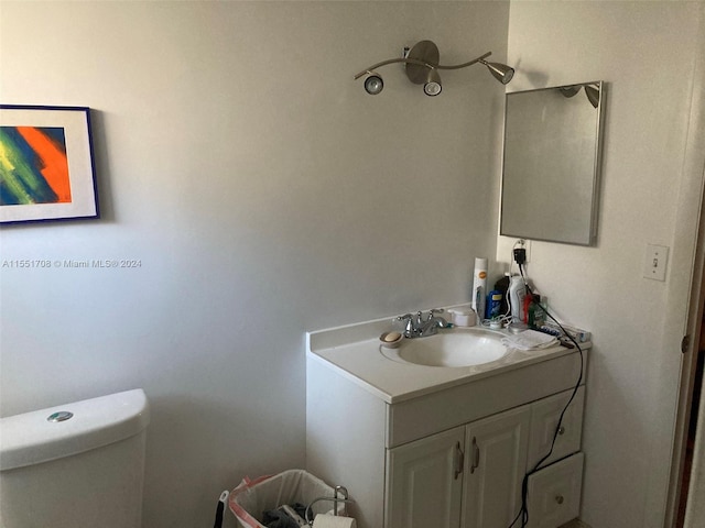 bathroom featuring toilet and vanity