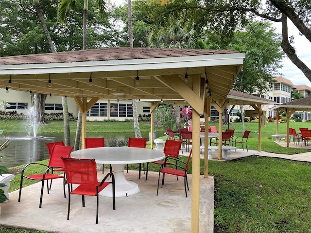 view of property's community featuring a patio, a gazebo, and a yard