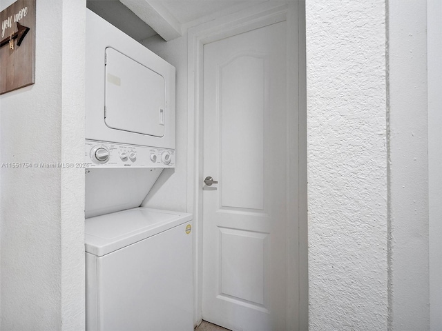 washroom featuring stacked washer / dryer