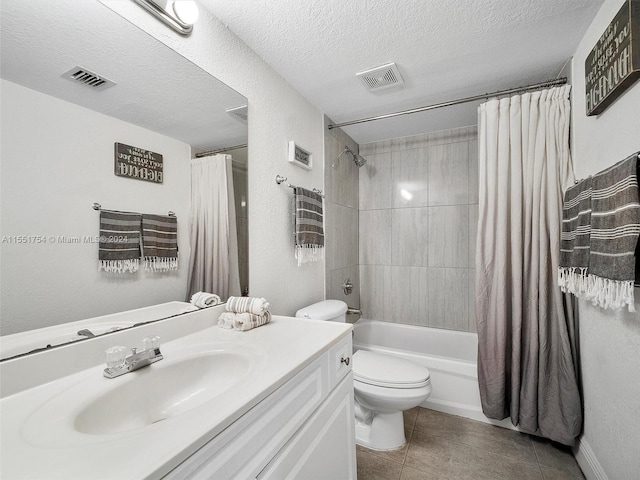 bathroom with tile patterned flooring, visible vents, a textured ceiling, and toilet