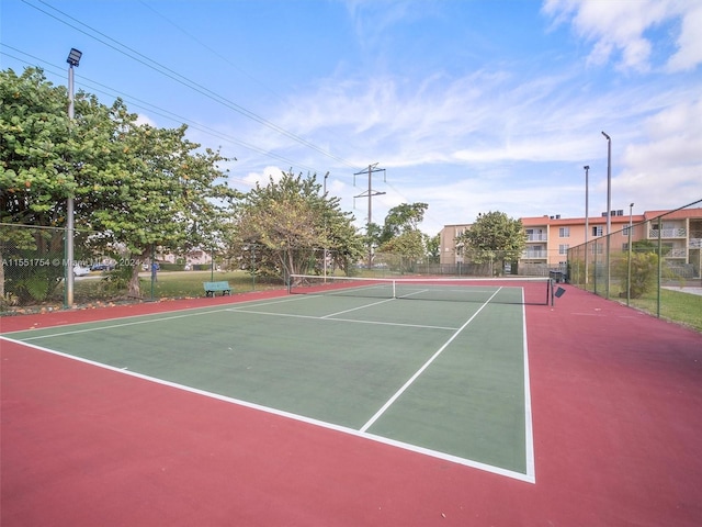 view of sport court featuring fence