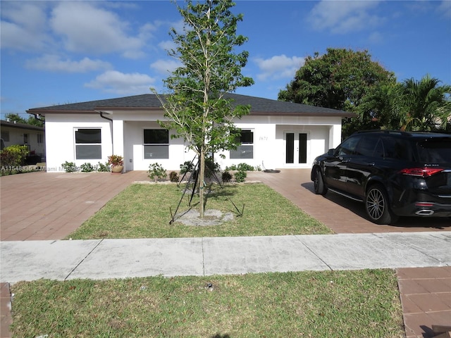 view of front of property with a front lawn and french doors