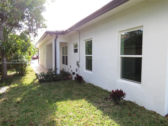 view of side of home with a lawn