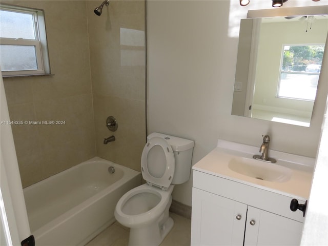 full bathroom featuring tiled shower / bath combo, toilet, and vanity