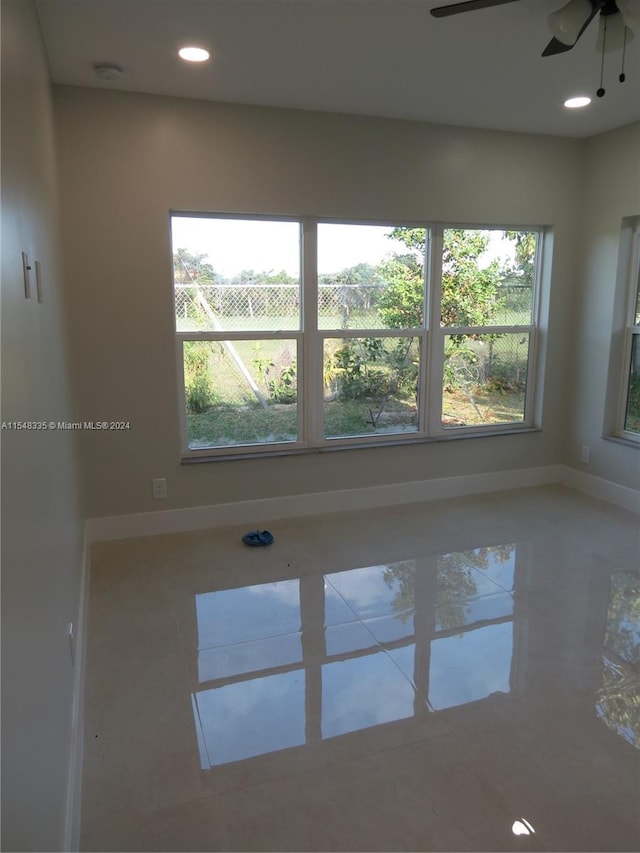 spare room with plenty of natural light and ceiling fan