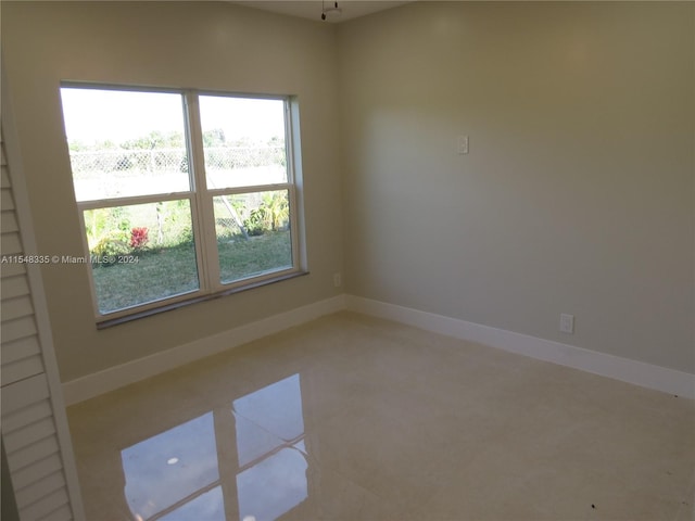 unfurnished room featuring plenty of natural light