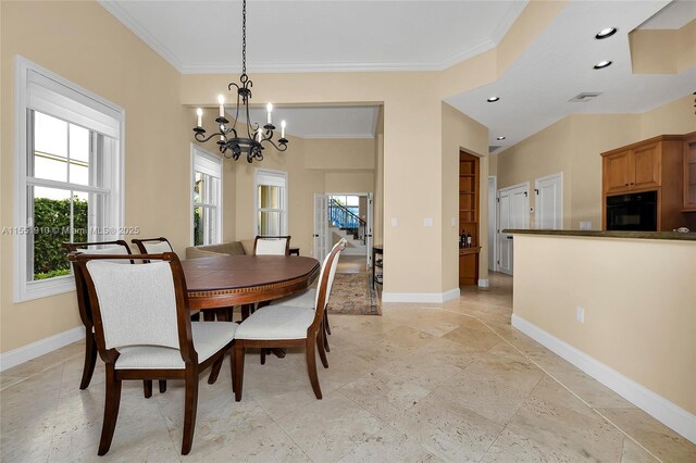 dining space with a chandelier and ornamental molding