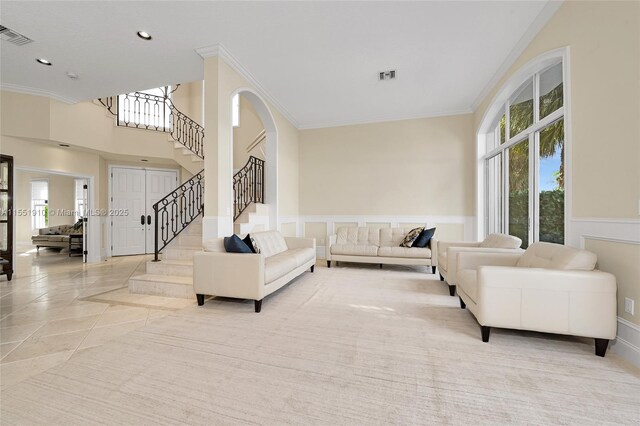 living room featuring crown molding and light tile patterned floors