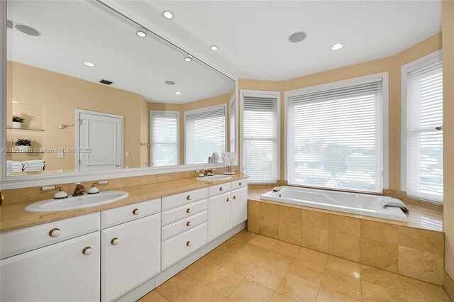 bathroom featuring tile patterned floors, a wealth of natural light, and vanity