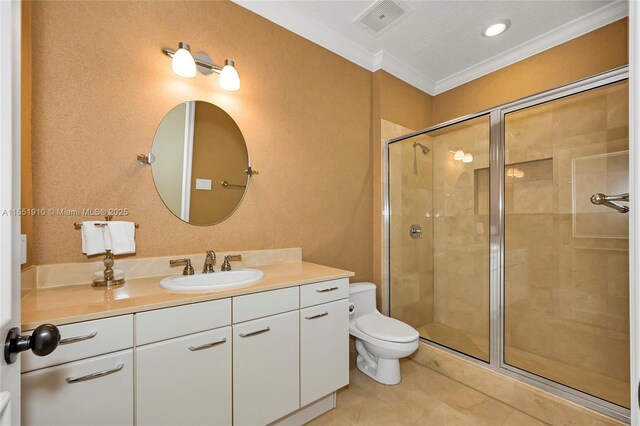 bathroom with vanity, crown molding, tile patterned flooring, toilet, and walk in shower