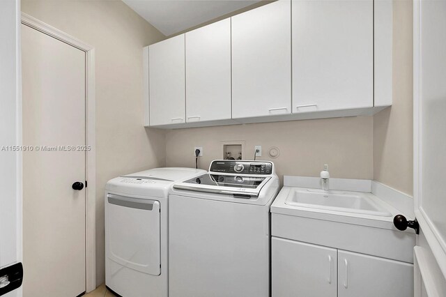 laundry area with cabinets, independent washer and dryer, and sink