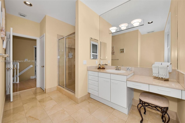 bathroom with tile patterned floors, vanity, and an enclosed shower