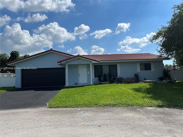 ranch-style home with a front lawn and a garage