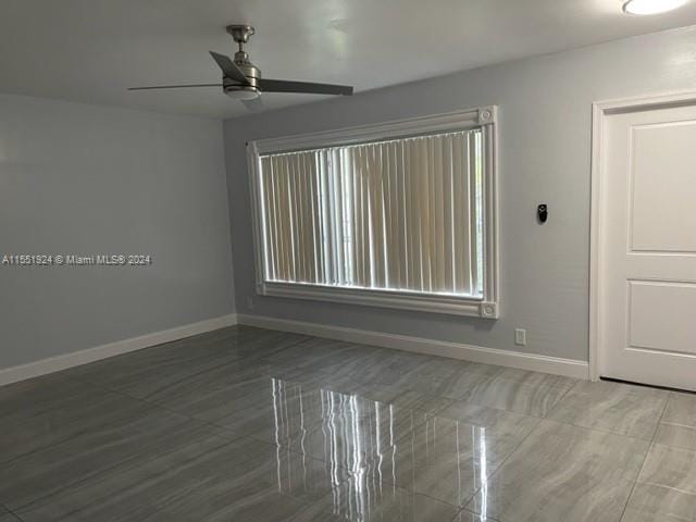 unfurnished room with ceiling fan