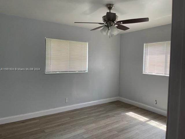 unfurnished room featuring dark hardwood / wood-style floors and ceiling fan