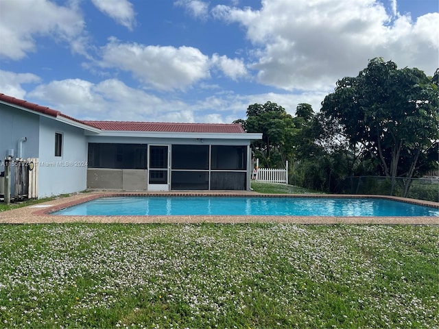 view of pool featuring a sunroom and a yard