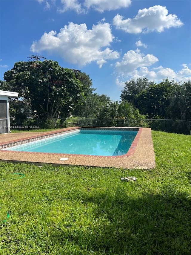 view of pool featuring a yard