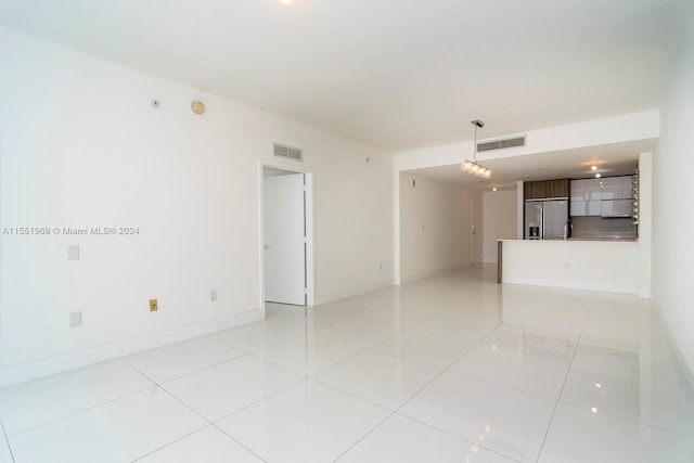 spare room with light tile floors