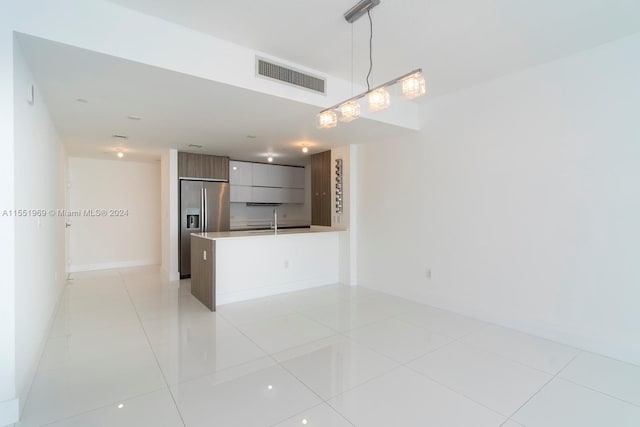 interior space with sink and light tile flooring