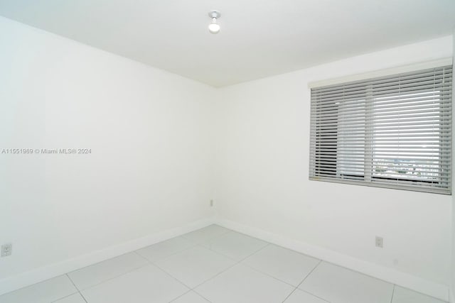 unfurnished room with light tile flooring