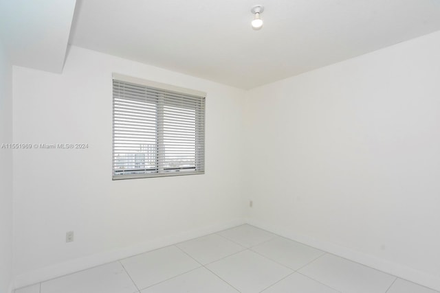 spare room featuring light tile flooring