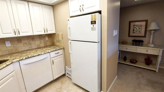 kitchen with tasteful backsplash, white appliances, light stone countertops, and white cabinets