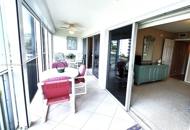 sunroom / solarium featuring ceiling fan