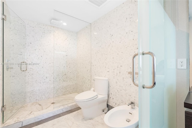 bathroom with a bidet, toilet, a shower with shower door, and tile flooring