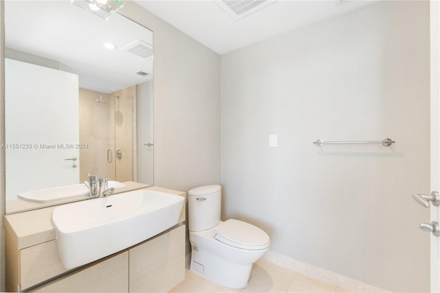 bathroom featuring tile floors, large vanity, and toilet