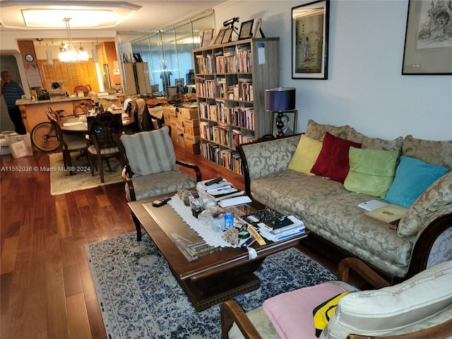 living room featuring a chandelier and hardwood / wood-style flooring