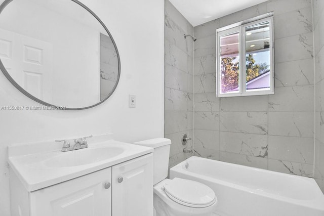 full bathroom featuring vanity, tiled shower / bath combo, and toilet