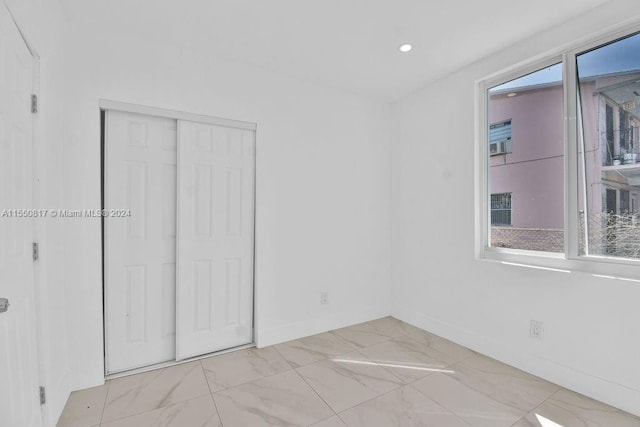 tiled spare room with plenty of natural light