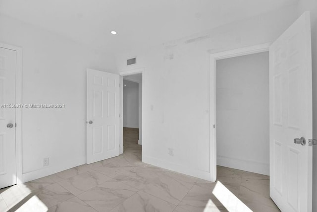 unfurnished bedroom with light tile flooring